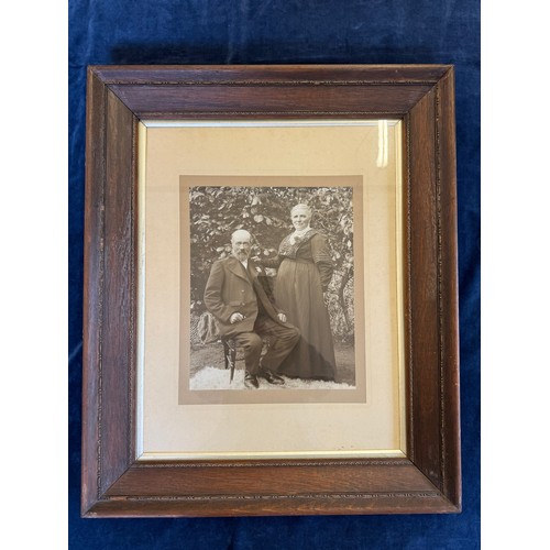 22 - A framed black and white photograph of a gentleman and lady.