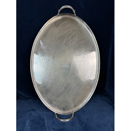 104 - A large oval silver-plate galleried tray.