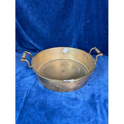 101 - A brass circular cooking pan with two handles