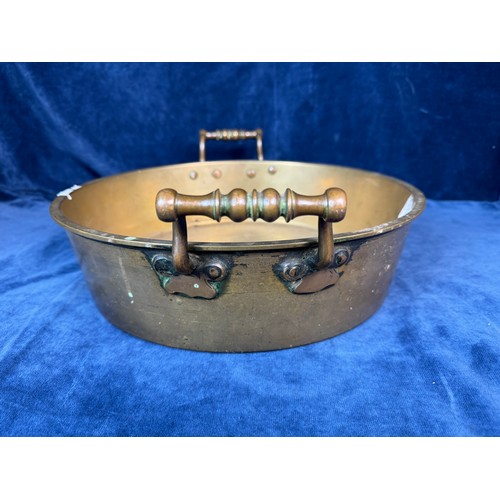 101 - A brass circular cooking pan with two handles