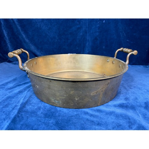 101 - A brass circular cooking pan with two handles