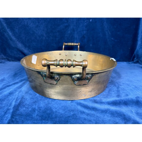 101 - A brass circular cooking pan with two handles