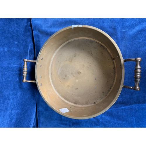 101 - A brass circular cooking pan with two handles