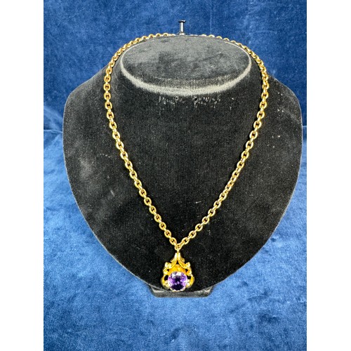 200 - A 9ct gold chain with gold metal pendant having large cut purple Amethyst style stone, the whole inc... 