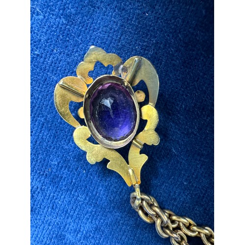 200 - A 9ct gold chain with gold metal pendant having large cut purple Amethyst style stone, the whole inc... 