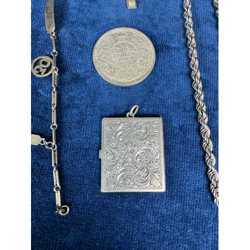 197 - A box containing a silver metal ladies stamp case, Eastern tassel end, child's silver necklace marke... 