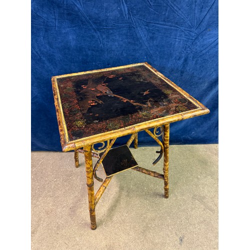 610 - A bamboo framed square side table having cross shaped stretcher, with hand painted top depicting bir... 