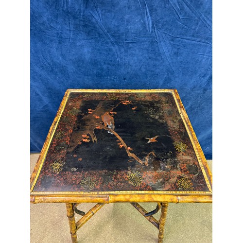 610 - A bamboo framed square side table having cross shaped stretcher, with hand painted top depicting bir... 