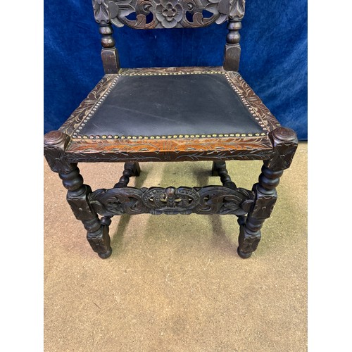 608 - An antique carved hall chair on turned legs and stretchers with barley twist side supports and carve... 