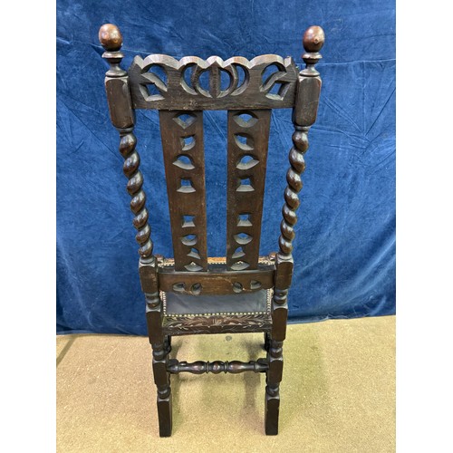 608 - An antique carved hall chair on turned legs and stretchers with barley twist side supports and carve... 