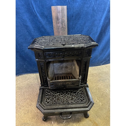 8 - A black enamel Queenie cast iron stove.