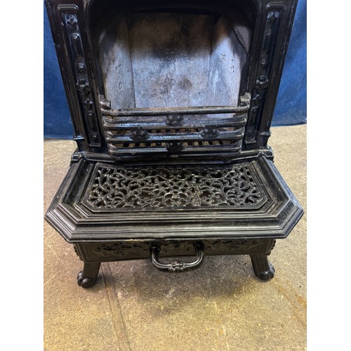 8 - A black enamel Queenie cast iron stove.