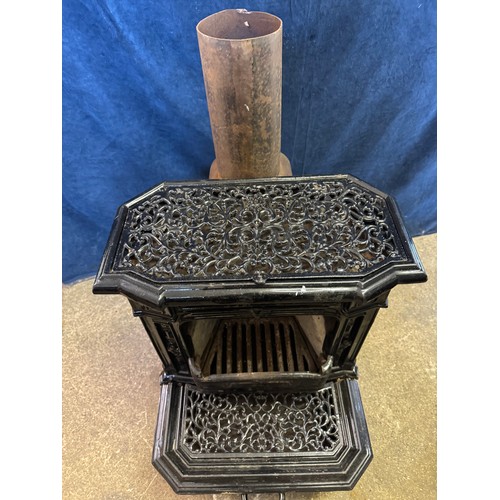 8 - A black enamel Queenie cast iron stove.