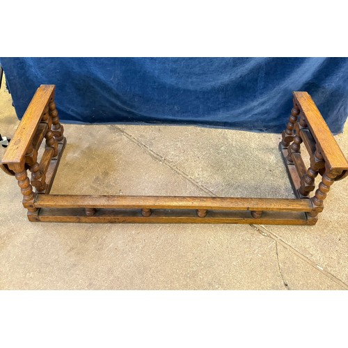 19 - A vintage oak fireside club fender with  drop leaf stool ends on turned gate leg supports. Internal ... 