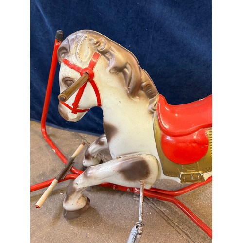 17 - A vintage metal child's toy rocking horse toy on springs, and red base frame.