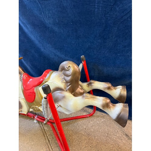 17 - A vintage metal child's toy rocking horse toy on springs, and red base frame.