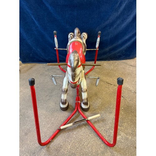 17 - A vintage metal child's toy rocking horse toy on springs, and red base frame.