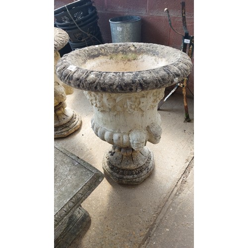 153 - PAIR OF CONCRETE URNS ON PLINTHS WITH GRAPE & HEAD DESIGN