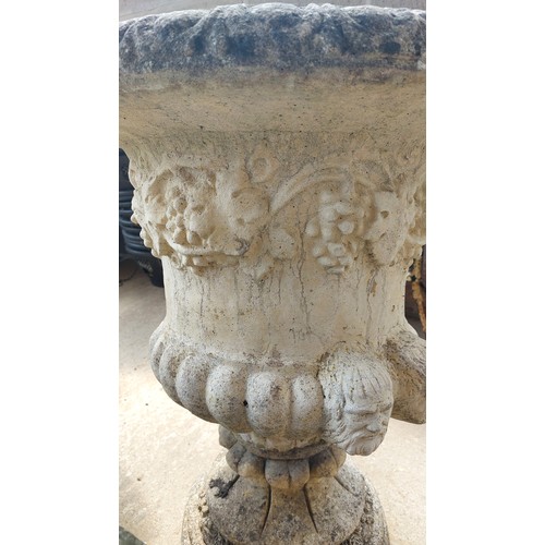 153 - PAIR OF CONCRETE URNS ON PLINTHS WITH GRAPE & HEAD DESIGN