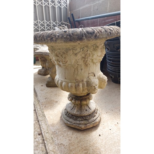 153 - PAIR OF CONCRETE URNS ON PLINTHS WITH GRAPE & HEAD DESIGN