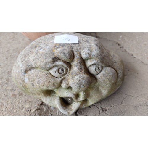 146 - A STONE FACE AND A TERRACOTTA PUMPKIN