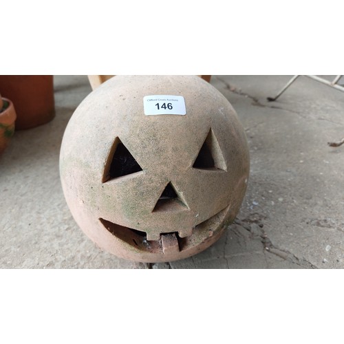 146 - A STONE FACE AND A TERRACOTTA PUMPKIN