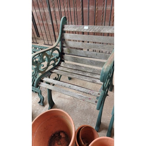 153 - 2 CAST IRON HEAVY ARMCHAIRS AND GARDEN TABLE ENDS