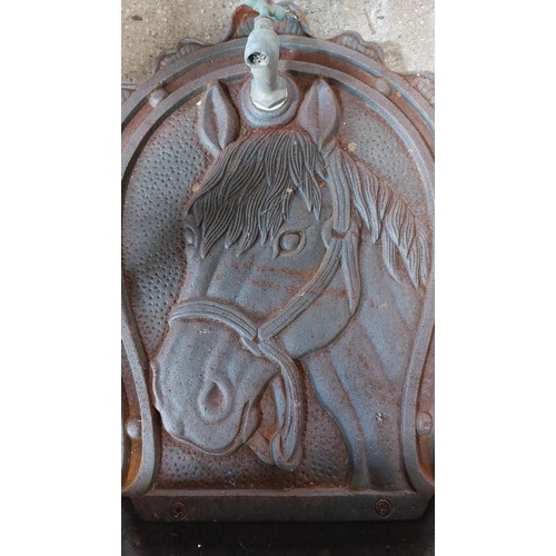 276 - A CAST IRON  WATER FEATURE (FOR WALL MOUNTING) WITH BRASS TAP AND BACK SPLASH WITH HORSE HEAD RELIEF... 