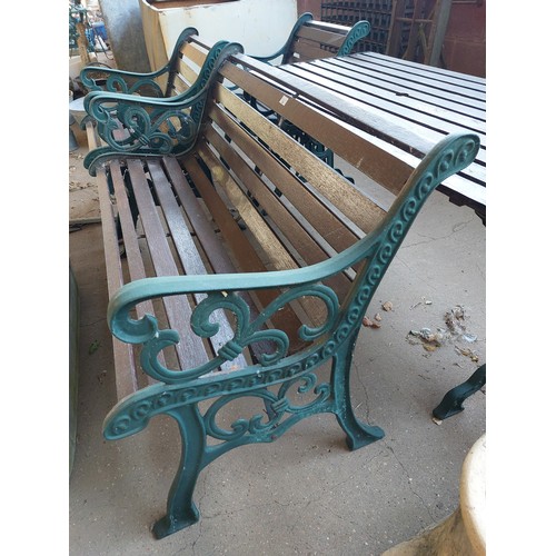 23 - CAST IRON AND WOODEN GARDEN SET COMPRISING BENCH, TABLE AND A PAIR OF GARDEN CHAIRS