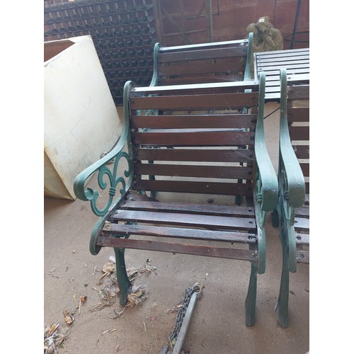 23 - CAST IRON AND WOODEN GARDEN SET COMPRISING BENCH, TABLE AND A PAIR OF GARDEN CHAIRS