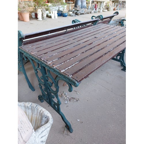 23 - CAST IRON AND WOODEN GARDEN SET COMPRISING BENCH, TABLE AND A PAIR OF GARDEN CHAIRS