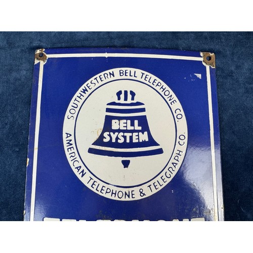 46 - A vintage enamel sign reading 'Southwestern Bell telephone Co - American telephone & telegraph Co - ... 