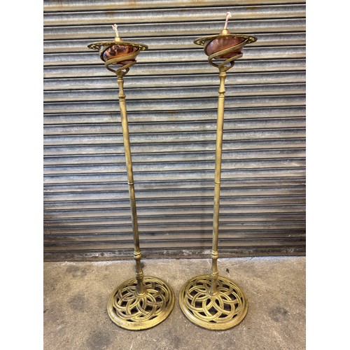 25 - A pair of cast iron oil lamp stands, each with a copper burner - stands painted a gold colour. 
Over... 