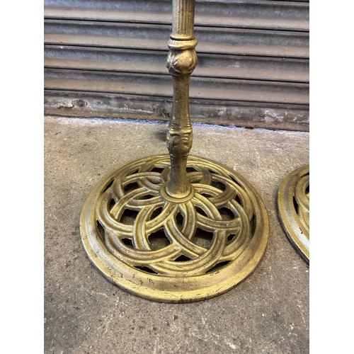 25 - A pair of cast iron oil lamp stands, each with a copper burner - stands painted a gold colour. 
Over... 