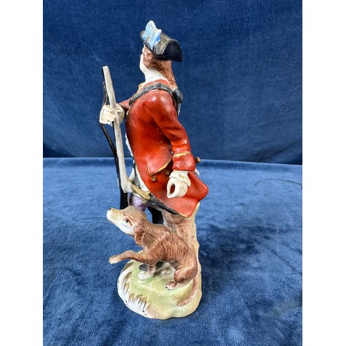 216 - A pair of Dresden porcelain figures depicting a huntsman with rifle and a dog, and a lady holding a ... 