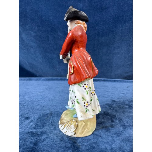 216 - A pair of Dresden porcelain figures depicting a huntsman with rifle and a dog, and a lady holding a ... 