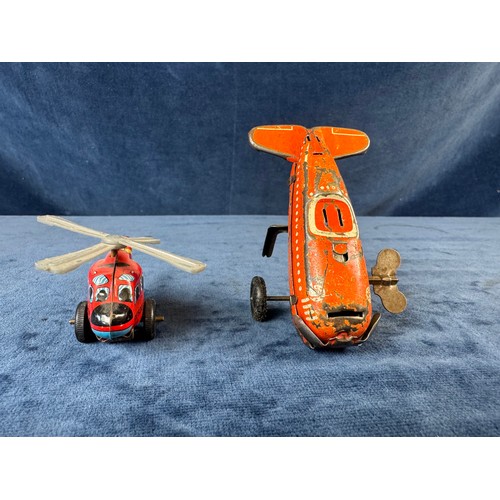 248 - A collection of 8 tin plate toy vehicles, including; A Kanto toys fire engine, 2 helicopters, police... 