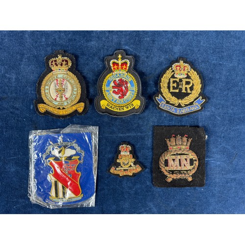 164 - A bomber command badge, together with other fabric badges.