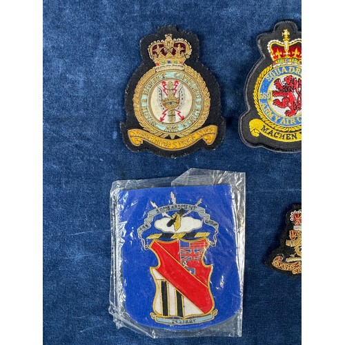 164 - A bomber command badge, together with other fabric badges.