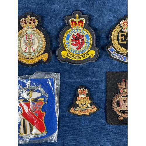 164 - A bomber command badge, together with other fabric badges.