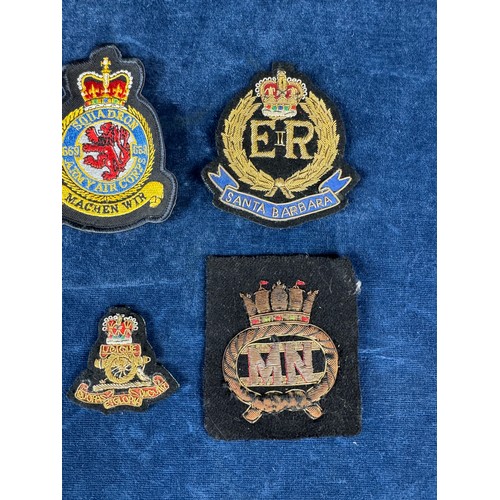 164 - A bomber command badge, together with other fabric badges.