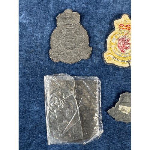 164 - A bomber command badge, together with other fabric badges.