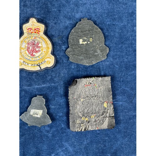 164 - A bomber command badge, together with other fabric badges.