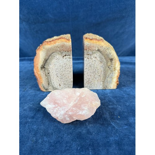 269 - A pair of polished and natural agate bookends together with a rough piece of rose quartz.