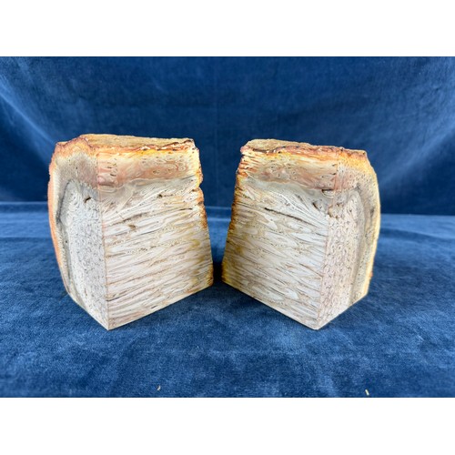 269 - A pair of polished and natural agate bookends together with a rough piece of rose quartz.