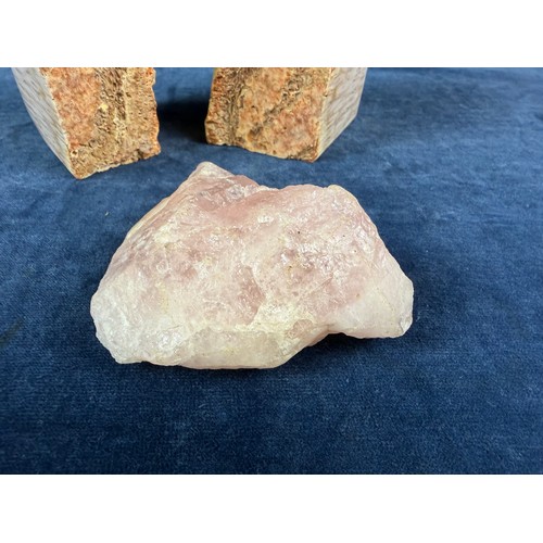 269 - A pair of polished and natural agate bookends together with a rough piece of rose quartz.
