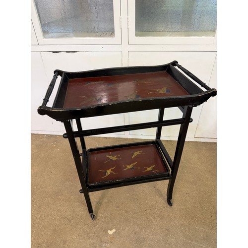 449 - An ebonised tea trolley in the oriental design, having hand painted bird decoration, with a removabl... 