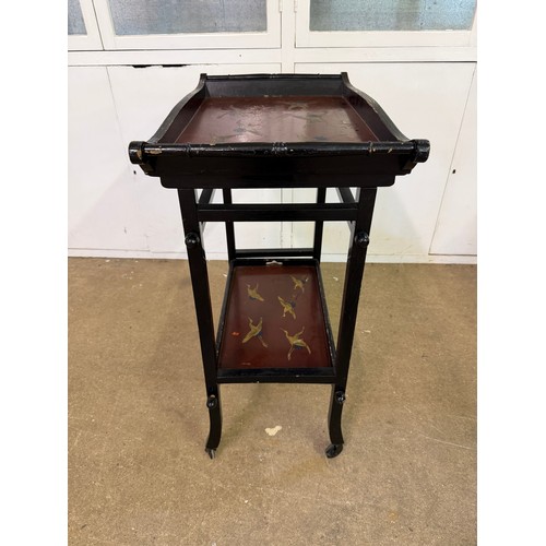 449 - An ebonised tea trolley in the oriental design, having hand painted bird decoration, with a removabl... 
