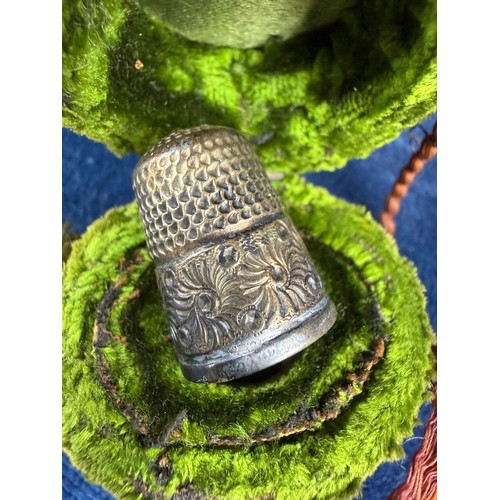 174 - A small collection of interesting items, comprising; a metal thimble in case, a USA half dollar moun... 