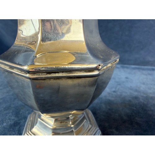 100 - A silver sugar shaker of plain design and pierced top, hallmarked London 1933-1934, makers mark J. W... 
